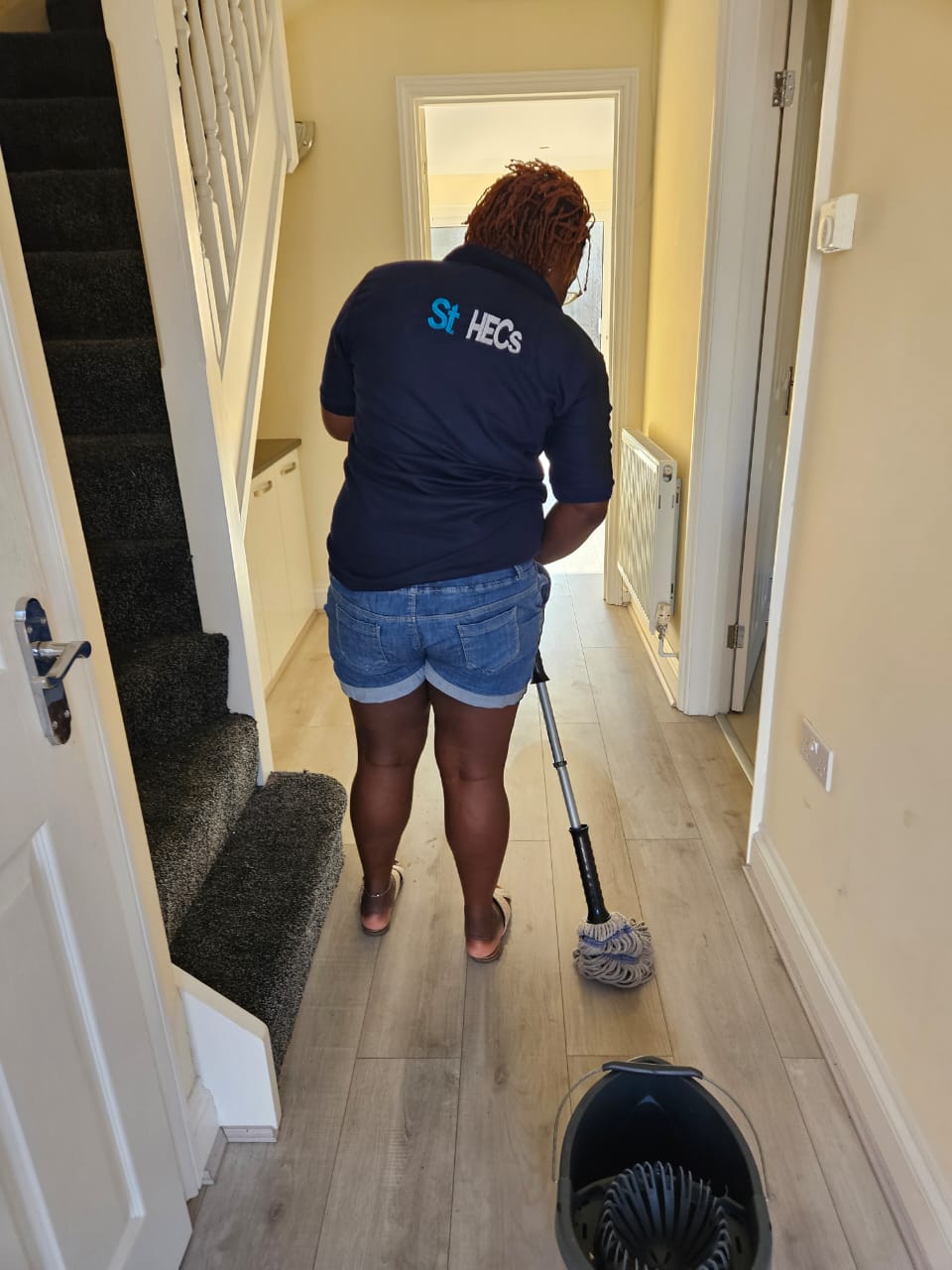 ST HECS cleaner in branded uniform at work in a Luton home